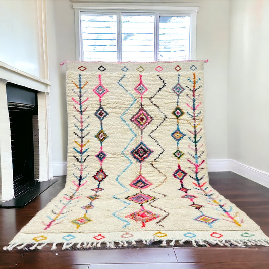 Full view of a handwoven geometric diamond Azilal Moroccan rug with a repeating diamond motif and vibrant colors.