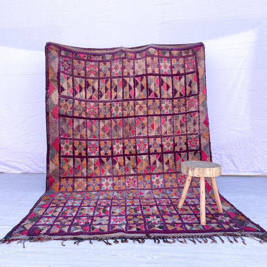 Full view of a multi-colored grid handwoven wool Boujaad Moroccan rug.